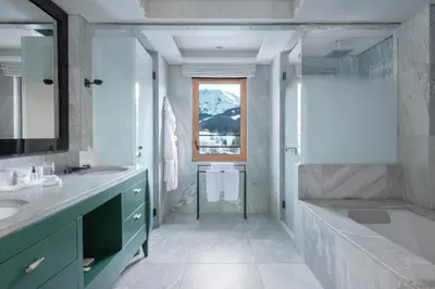 a bathroom with two sinks and a tub and a shower at Four Seasons Resort Megève in Megève