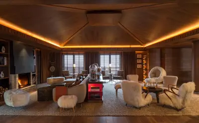 a living room with chairs and a fireplace at Four Seasons Resort Megève in Megève