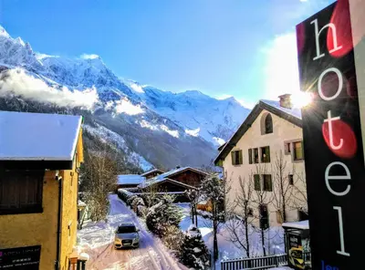 a view of a snow covered mountain from a building at Hotel Les Lanchers in Chamonix-Mont-Blanc