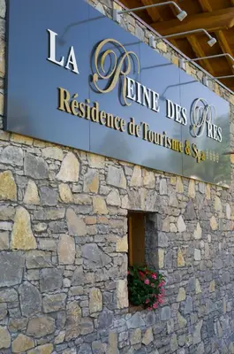 a sign on the side of a stone building at CGH Résidences & Spas La Reine des Prés in Samoëns