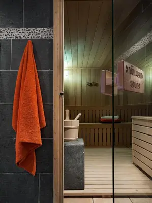 a bathroom with a shower with a towel at CGH Résidences & Spas Les Chalets de Jouvence in Les Carroz d'Araches