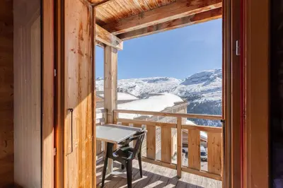 a bedroom with a large bed and a window at Dormio Resort Les Portes du Grand Massif in Flaine