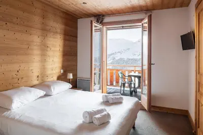 a swimming pool in a house with a view at Dormio Resort Les Portes du Grand Massif in Flaine