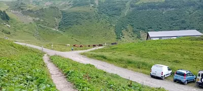 two cars parked on a dirt road in a mountain at résidence Le Platé in Les Carroz d'Araches
