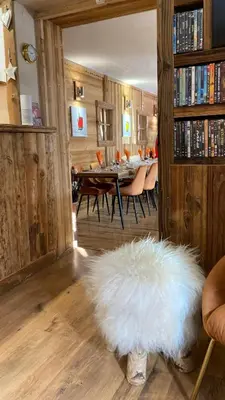 a living room with a table and a white rug at Hôtel Les Cimes in Megève