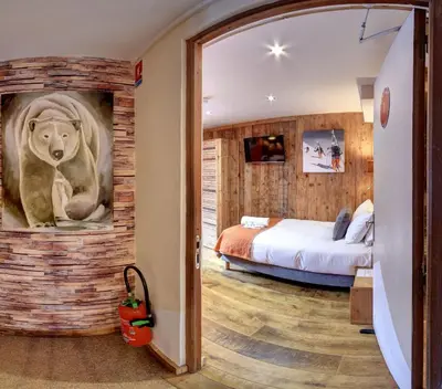 a bedroom with a lion painting on the wall at Hôtel Les Cimes in Megève