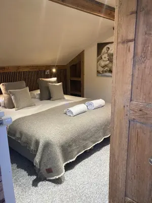 a bedroom with two beds with towels on them at Hôtel Les Cimes in Megève