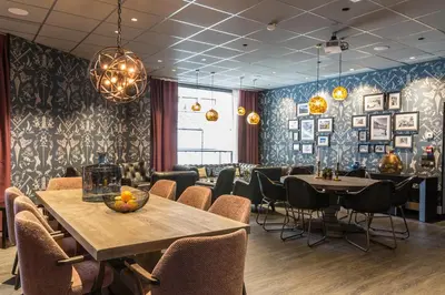 a dining room with tables and chairs in a restaurant at Pointe Isabelle in Chamonix-Mont-Blanc