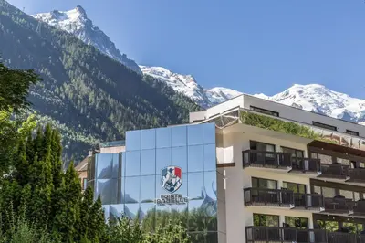 a building with a reflection of a mountain at Pointe Isabelle in Chamonix-Mont-Blanc