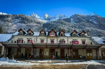 a large building with mountains in the background at Chalet Les Frenes in Chamonix-Mont-Blanc
