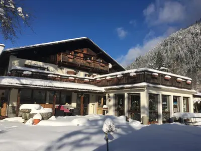 a building with snow on the ground in front of it at Chalet l'Aiglon in Saint-Gervais-les-Bains
