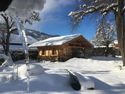 a log cabin in the snow with a snowboard at Chalet l'Aiglon in Saint-Gervais-les-Bains