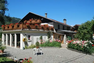 a house with a balcony on top of it at Chalet l'Aiglon in Saint-Gervais-les-Bains