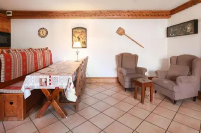 a living room with a table and two chairs at Residence La Ginabelle - maeva Home in Chamonix-Mont-Blanc