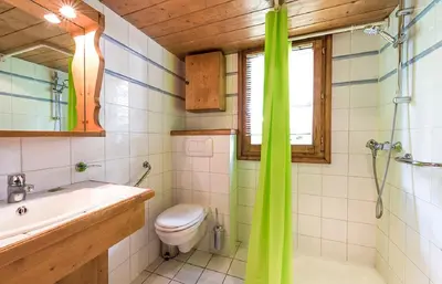a bathroom with a toilet and a sink and a shower at Residence La Ginabelle - maeva Home in Chamonix-Mont-Blanc