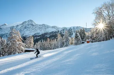 a person is skiing down a snow covered slope at APARTMENT REFUGE DE BELLACHAT - Alpes Travel - Les Houches - Sleeps 4 in Les Houches