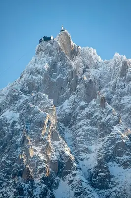 a man standing on the top of a mountain at APARTMENT REFUGE DE BELLACHAT - Alpes Travel - Les Houches - Sleeps 4 in Les Houches