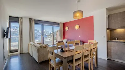 a kitchen and dining room with a table and chairs at Madame Vacances Les Terrasses De Véret in Flaine