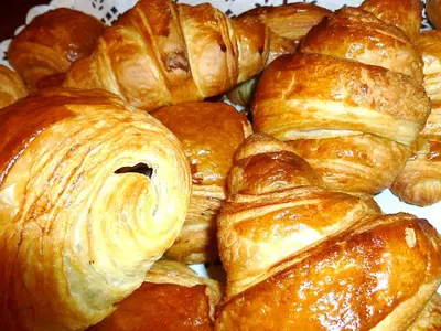 a pile of croissants and other pastries on a plate at Aiguille du Midi - Hôtel & Restaurant in Chamonix-Mont-Blanc