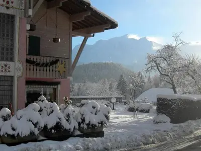 a building with snow covered bushes in front of it at Le Cordonant in Cordon