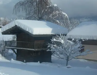 a log cabin with snow on top of it at Le Cordonant in Cordon