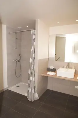a bathroom with a shower and a sink at Hôtel Val d'Este in Saint-Gervais-les-Bains