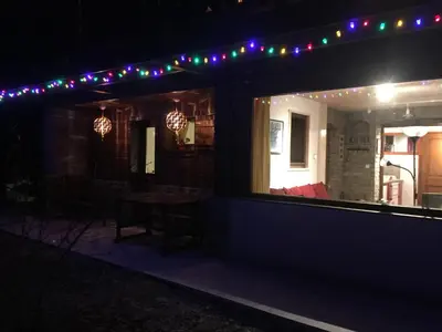 a house with a patio at night with lights at Chalet Champraz - Free Parking in Chamonix-Mont-Blanc