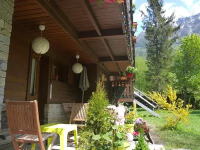 a porch of a house with a table and chairs at Chalet Champraz - Free Parking in Chamonix-Mont-Blanc