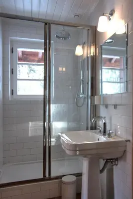 a white bathroom with a sink and a shower at La Ribambelle in Chamonix-Mont-Blanc
