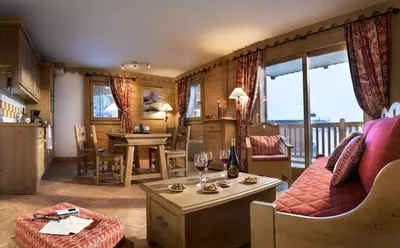 a living room with a couch and a table at CGH Résidence Boutique Le Hameau De Pierre Blanche in Les Houches