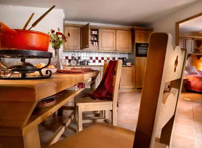 a kitchen with a wooden table with a pot on it at CGH Résidence Boutique Le Hameau De Pierre Blanche in Les Houches