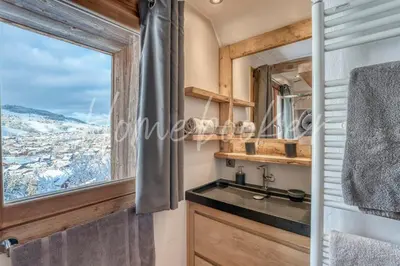 a bathroom with a sink and a window at Chalet Hermine in Megève