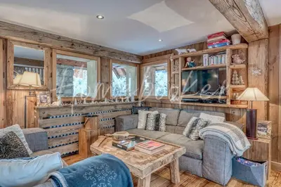 a living room with a couch and a table at Chalet Hermine in Megève