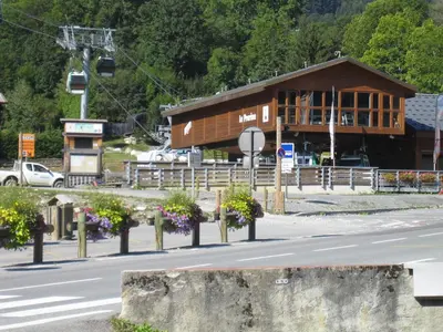 a building on the side of a road with flowers in front at Le Prarion 2 in Les Houches