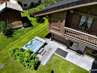 an aerial view of a house with a hot tub in the yard at Chalet Luxe Les Mélèzes in Samoëns