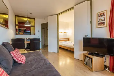 a living room with a couch and a flat screen tv at Apartment Chamois Blanc 6 - Chamonix Haven with great views in Chamonix-Mont-Blanc