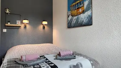 a bedroom with a bed and a painting on the wall at Au Pied Du Mont-Blanc - Chamonix in Chamonix-Mont-Blanc