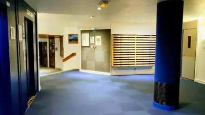 a hallway with a blue pillar in a building at Au Pied Du Mont-Blanc - Chamonix in Chamonix-Mont-Blanc
