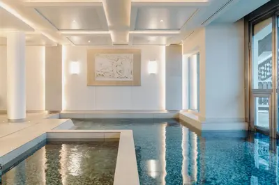a pool in the middle of a room with water at Les Chalets du Mont d'Arbois & Spa, Megève in Megève
