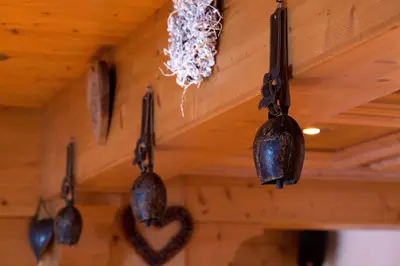 a group of utensils hanging from a ceiling at Hôtel La Grange d'Arly in Megève