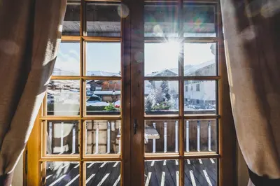 a window with a view of a city at Hôtel La Grange d'Arly in Megève