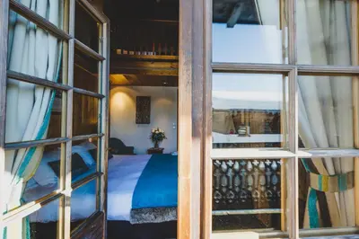 a view of a room with a bed through a window at Hôtel La Grange d'Arly in Megève