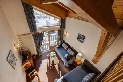 an overhead view of a living room with a blue couch at Hôtel La Grange d'Arly in Megève