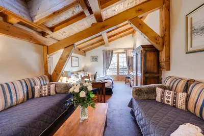 a living room with couches and a table at Hôtel La Grange d'Arly in Megève