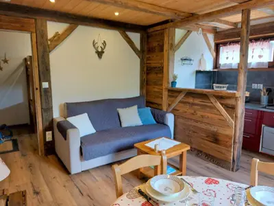 a living room with a couch and a table at Studio Castel des roches by Interhome in Saint-Gervais-les-Bains