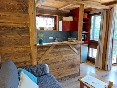 a living room with a couch and a kitchen at Studio Castel des roches by Interhome in Saint-Gervais-les-Bains