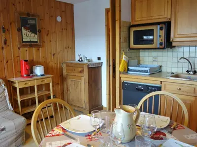 a kitchen with a table and a sink and a microwave at Studio La pointe des Aravis 4 by Interhome in Saint-Gervais-les-Bains