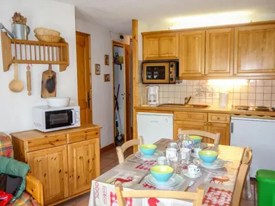 a kitchen with a table with dishes on it at Apartment Jardins Alpins 5 by Interhome in Saint-Gervais-les-Bains