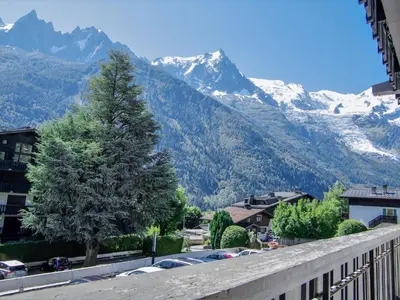 a view of a mountain from a balcony with a tree at Apartment Le Brévent-22 by Interhome in Chamonix-Mont-Blanc