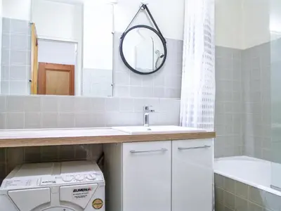 a bathroom with a sink and a washing machine at Apartment Le Brévent-22 by Interhome in Chamonix-Mont-Blanc